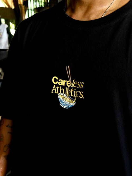 Black t-shirt with 'Careless Athletics' logo worn by a person.