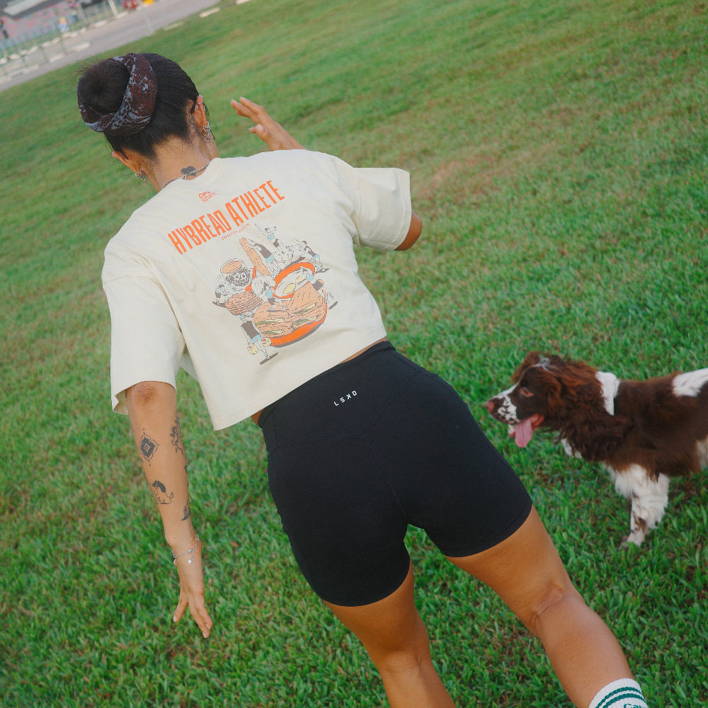 Person playing with a dog in a grassy field