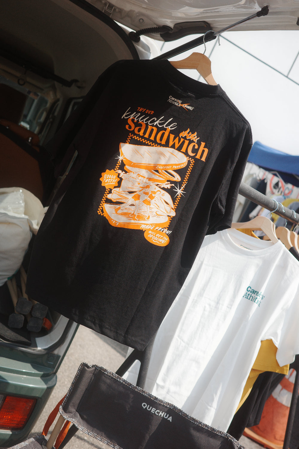 Black T-shirt with sandwich graphic on a vehicle 