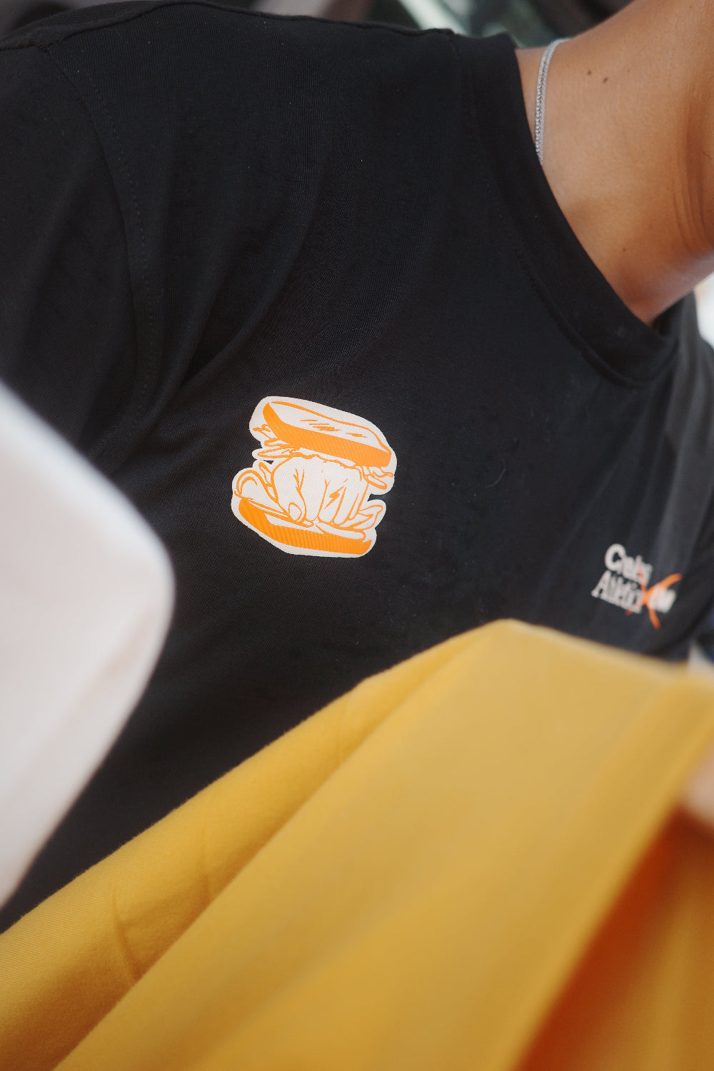 Front of t-shirt with white and orange logo